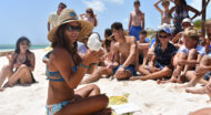 Staff members teaching campers on the beach.