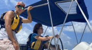 Staff members driving a boat.